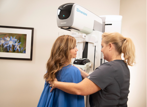 Photo of doctor positioning a patient for a mammogram